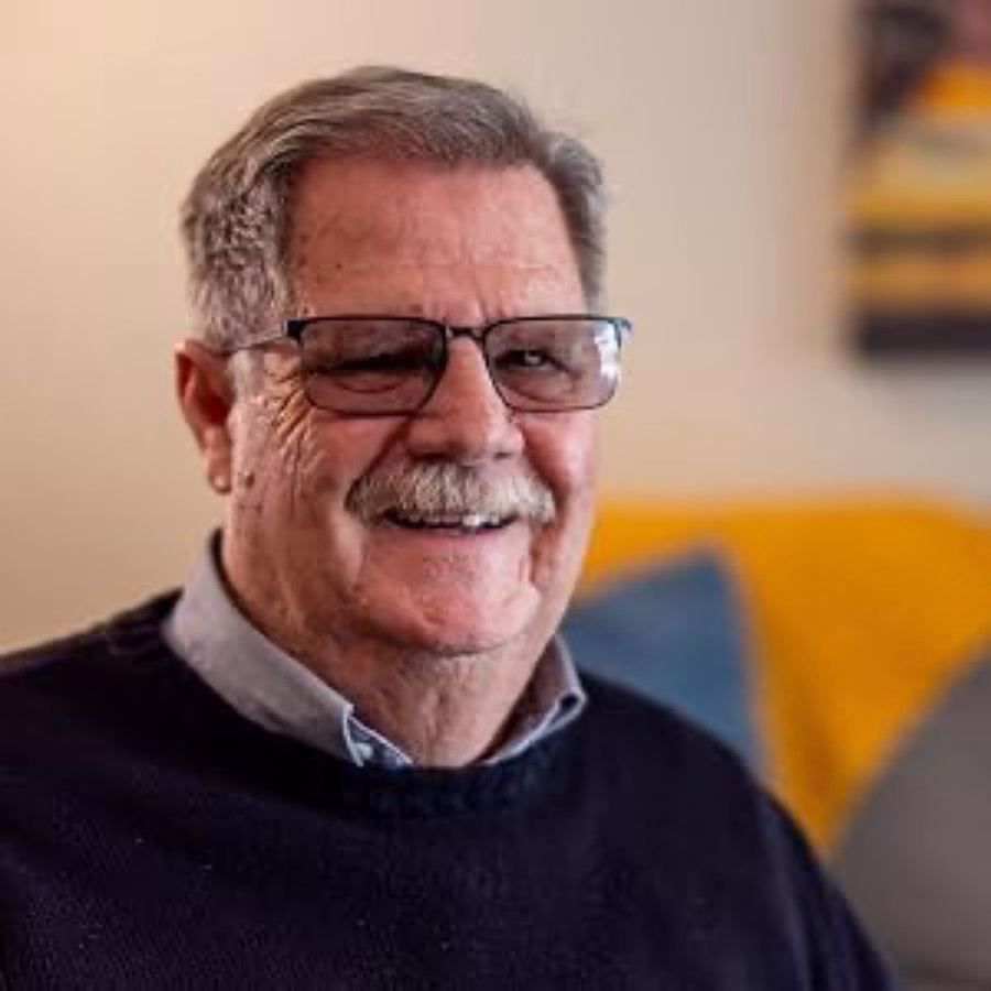 Author Richard Enns, smiling, in glasses and a dark sweater